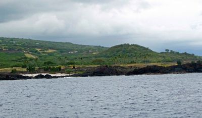 Isolated white sand beach among lava deposts along the Kona coast