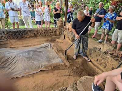 Uncovering the IMU (Hawaiian Underground Oven) at Luau on Kauai