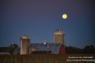 Setting full moon and Wisconsin barn