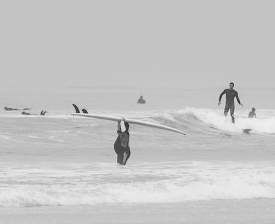 Surfers on a Foggy Morning