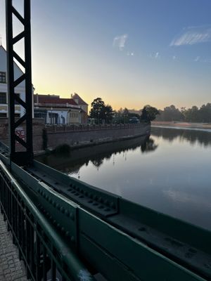 Quiet view of the river, no cars, few people.