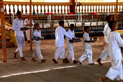 MONKS FEEDING THE ELDERLY AND DISABLED