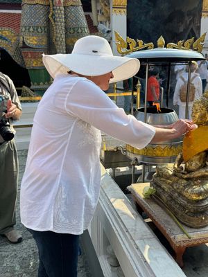 JANE PUTS GOLD LEAF ON A BUDDHA