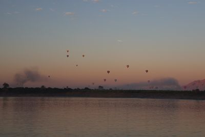 HOT AIR BALLOONS RISE IN THE MORNING SUNRISE