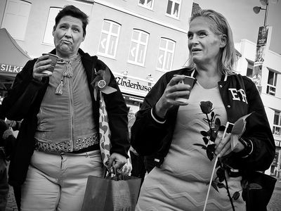 Shoppers with hot cups on a cold day