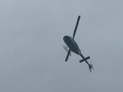 Helicopters flying in area for hours watching for murder suspect. 