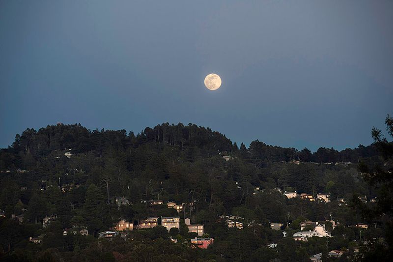 The moon rising over the Oakland Hills