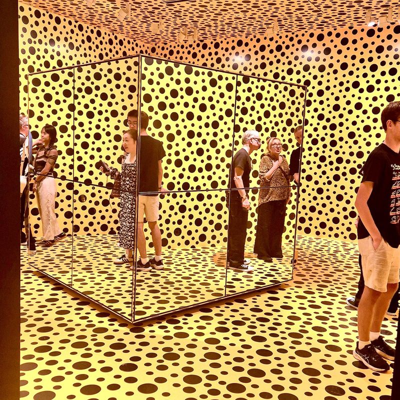 A small room of mirrors and spots