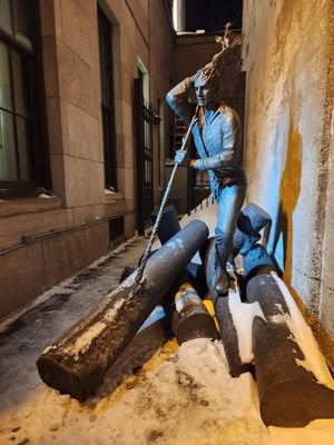 Price Memorial on Sainte Anne between two building titled L Homme Riviere The River man *a Log driver