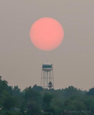 Red Sun From Wildfire Smoke Setting Beyond Water Tower 90D68561-7