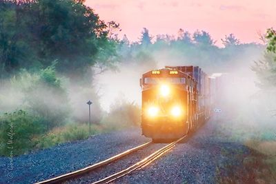 Freight Train Emerging From Fog At Sunrise 90D73960