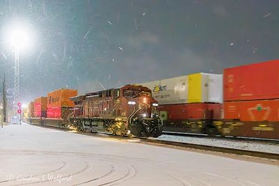 Eastbound & Westbound Night Trains Passing In Spring Snowfall 90D106516
