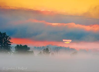 Sun Rising Into Cloud Beyond Ground Fog 90D117230