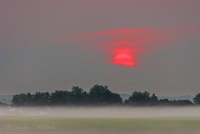 Clouded Red Sun Rising Beyond Ground Fog 90D120122