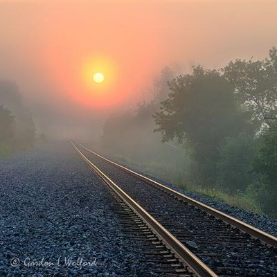Sun Rising Beyond Fog & Rails 90D126716-20