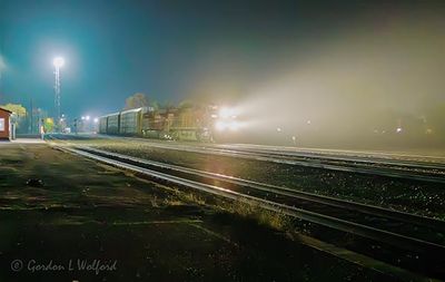 Departing Eastbound Freight Train In Night Fog 90D131674