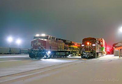 Two Westbound CPKC Trains On A Snowy Night 90D138123