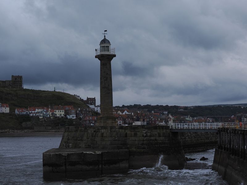 Whitby harbour lighthouse at dusk