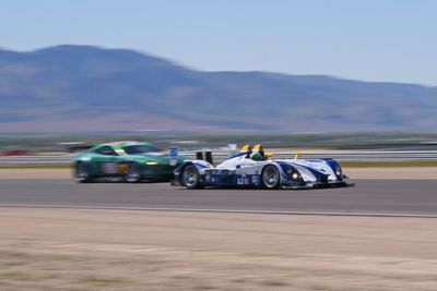 Porsche RS Spyder passing an Aston Martin.