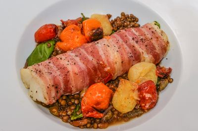 Pancetta-Wrapped Cod with Lentils and Tomatoes.