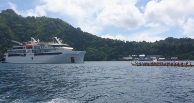 Canoe escort for Coral Adventurer, approaching Banda Neira, Indonesia