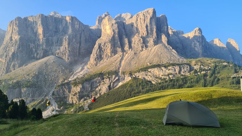 Camp with Sella cliffs rising to south