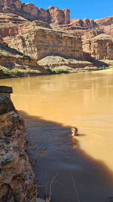 Day 8 Martina swims in the muddy Green River at bottom of Powell Canyon- refreshing!