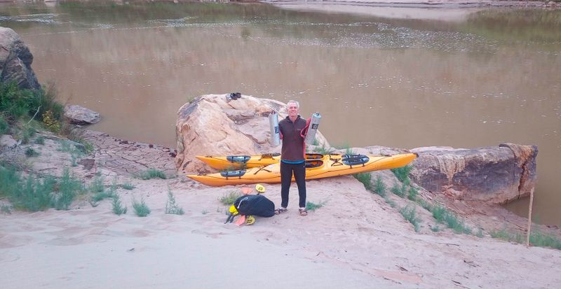 Day 9 In morning waiting for a jet boat pick up, Brian with poo containers!