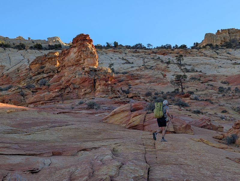 Brian climbing the colourful rock slabs