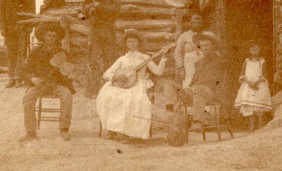Western Home 1885 no arm fiddle Musician crop.jpg