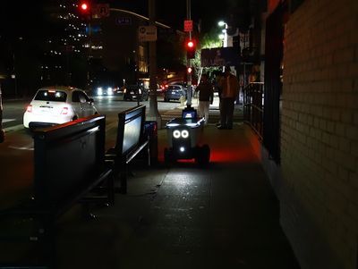 A Delivery Robot Tooling Down the Sidewalk in Los Angeles