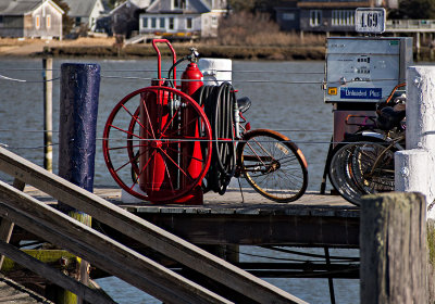 bikes, fuel pump, red fire extinguisher, purple post, green algae