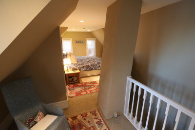 third floor master suite looking into main room from top of stairs