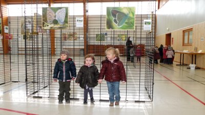 Three cute kids pose in front of my butterflies