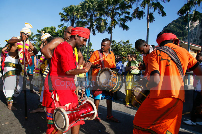 Urumi melam drummers accompany the devotees