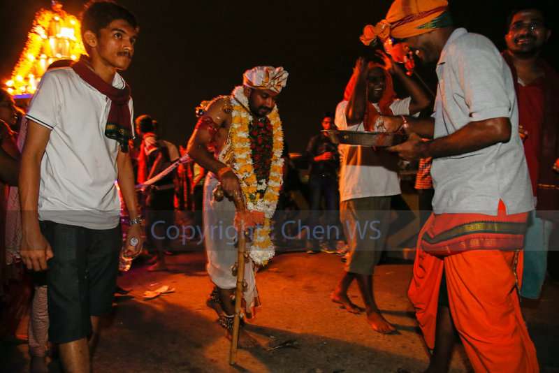 Devotee pulling a cart by hooks on his back