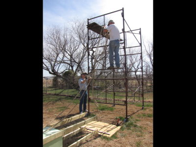 We put the rope over one of the bars of the scaffold to help pull it up from one side as we were pushing from the other.