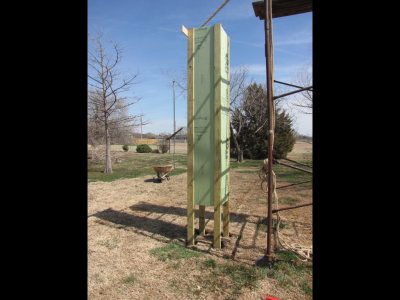 We really needed a photographer on hand.  Mary wasn't able to record the next big move, because she was a part of it too.  Bill and I lifted the tower while Mary pulled the plywood out from under the legs.  Then we let the legs down into the holes.