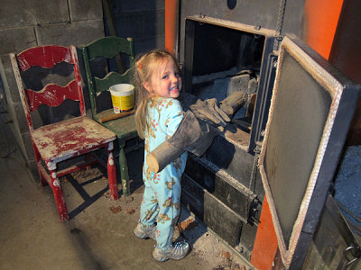 Kristina helps stoke the furnace