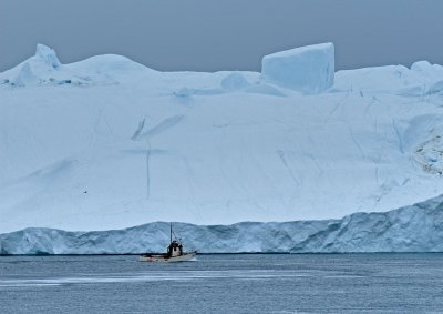 Fishing boat passes an iceberg