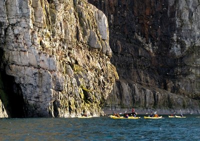 The kayaks approach the cliffs