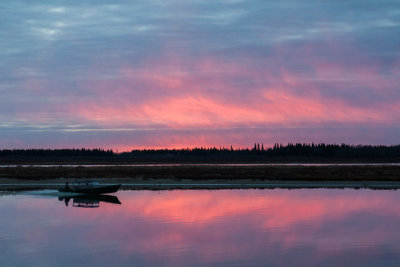 Taxi boat and cloudy sunrise.