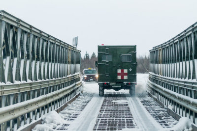 Army ambulance crossing bailey bridge on way to Moosonee Airport.