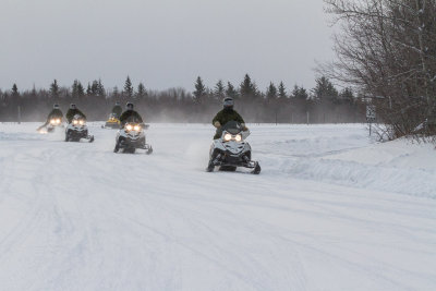 Soldiers on snowmobiles arriving at Moosonee Airport