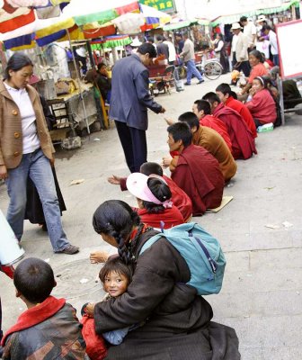 In Lhasa Tibet, monks, children and mothers begging for money.