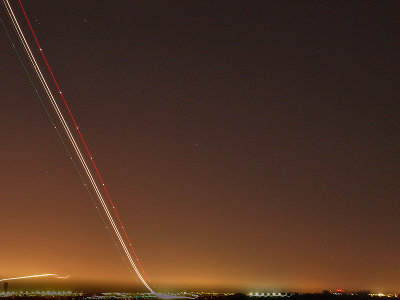 Tme lapse photo of A/C taking off at night.