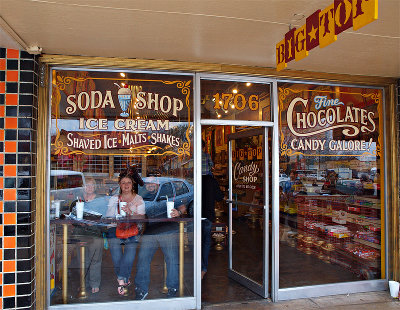 Candy shop windows and door with  customers in window