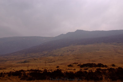 I think the jagged mountain is Glyder Fach; taken from Pen y Gwryd