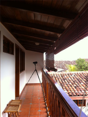 upstairs balcony- to left is our room.  Spotting scope in position. We saw many birds from here.