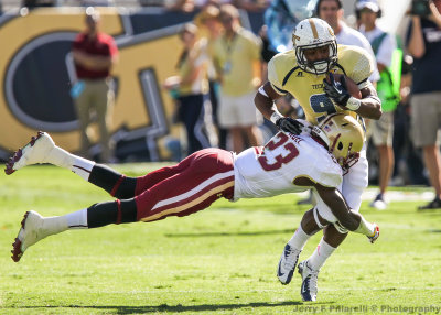 Jackets A-back Zenon is hit in the open field by Eagles DB Jim Noel…